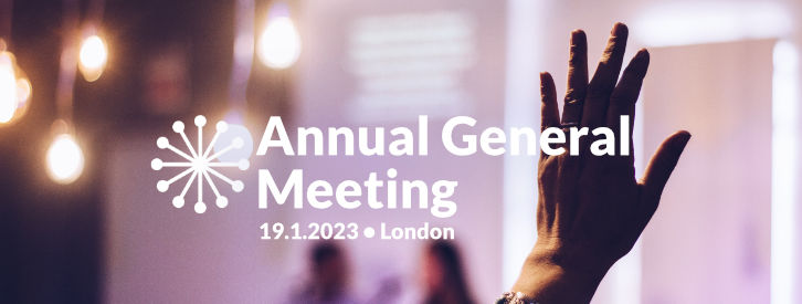 photo showing a raised hand at a meeting with text overlay: Annual General Meeting 19.1.2023 London
